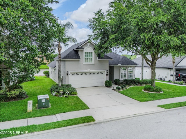 11582 Wynnfield Lakes Cir, Jacksonville, FL 32246 - traditional home featuring stucco siding, a front lawn, concrete driveway, a garage, and roof with shingles
