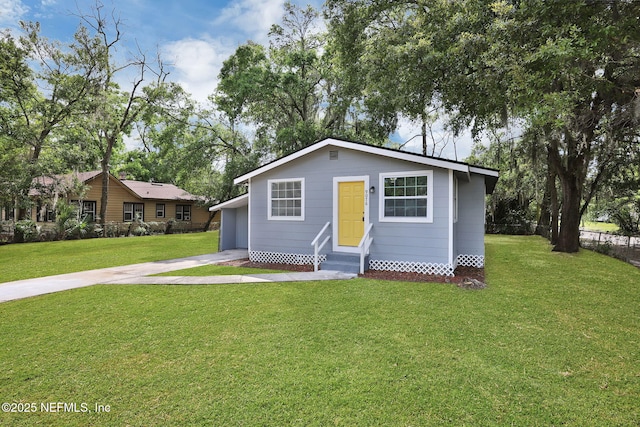 9076 1st Ave, Jacksonville, FL 32208 - bungalow-style house featuring entry steps, a front yard, and concrete driveway
