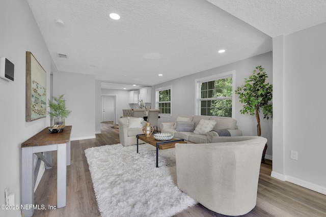 9076 1st Ave, Jacksonville, FL 32208 - living room with a textured ceiling, wood finished floors, and recessed lighting