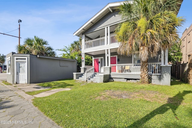 918 King St, Jacksonville, FL 32204 - view of front of house featuring a porch, a balcony, and an outbuilding