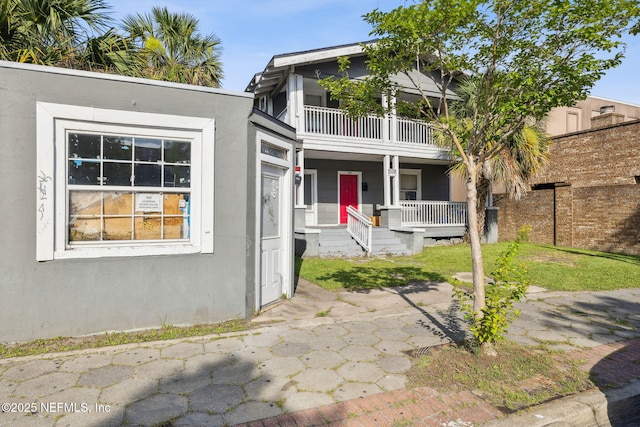 918 King St, Jacksonville, FL 32204 - view of front facade featuring a porch, a balcony, and stucco siding