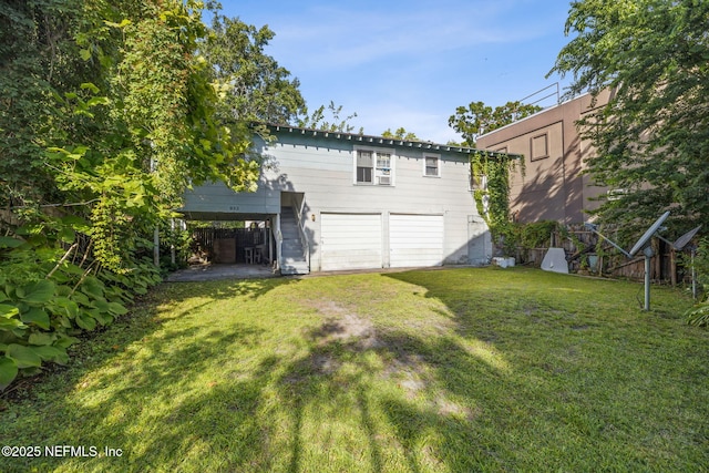 918 King St, Jacksonville, FL 32204 - rear view of house with a yard and an attached garage