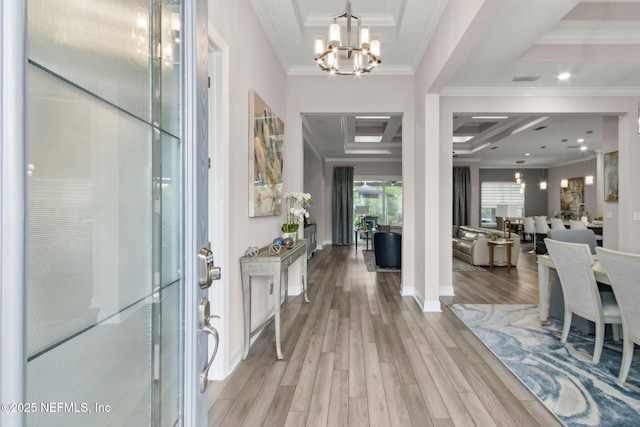 95158 Sandy Pointe Dr, Fernandina Beach, FL 32034 - foyer with light wood-style floors, a chandelier, crown molding, and coffered ceiling