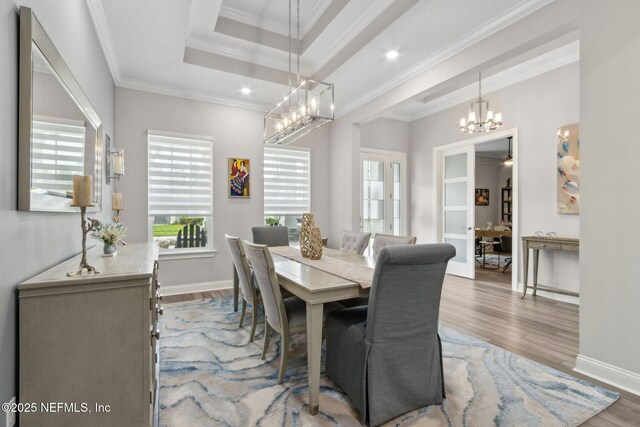 95158 Sandy Pointe Dr, Fernandina Beach, FL 32034 - dining space with a chandelier, wood finished floors, ornamental molding, a tray ceiling, and recessed lighting