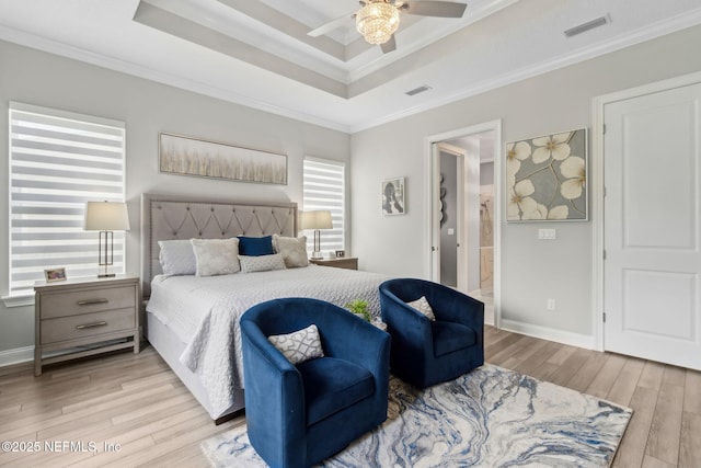 95158 Sandy Pointe Dr, Fernandina Beach, FL 32034 - bedroom with a raised ceiling, light wood-style floors, crown molding, ensuite bathroom, and ceiling fan