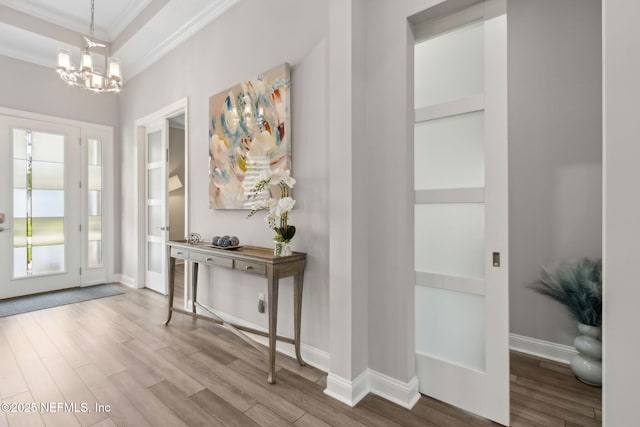 95158 Sandy Pointe Dr, Fernandina Beach, FL 32034 - foyer with ornamental molding, wood finished floors, and a chandelier