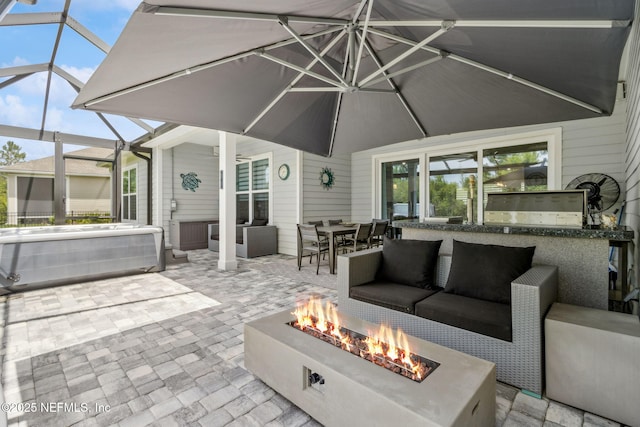 95158 Sandy Pointe Dr, Fernandina Beach, FL 32034 - view of patio featuring a hot tub, an outdoor living space with a fire pit, glass enclosure, and an outdoor kitchen