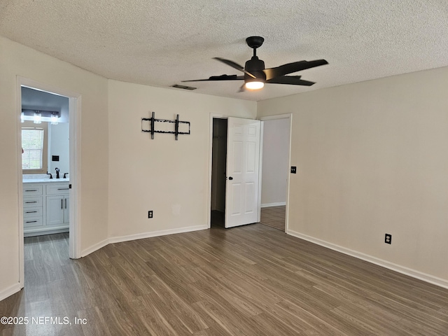 1203 Stern Way, Fleming Island, FL 32003 - unfurnished room with wood finished floors, a ceiling fan, a textured ceiling, baseboards, and a sink