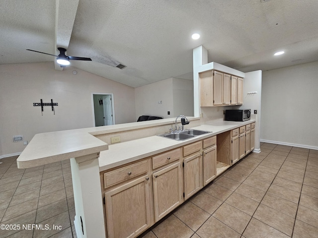 1203 Stern Way, Fleming Island, FL 32003 - kitchen with stainless steel microwave, a sink, a peninsula, light brown cabinetry, and light tile patterned floors