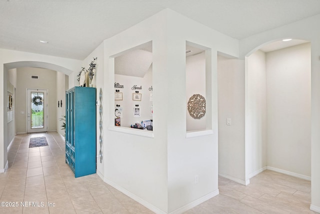 600 Broomsedge Cir, Saint Augustine, FL 32095 - hallway with arched walkways and light tile patterned flooring