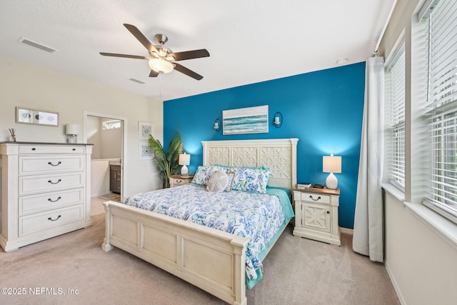 600 Broomsedge Cir, Saint Augustine, FL 32095 - bedroom featuring light colored carpet, a ceiling fan, and ensuite bathroom