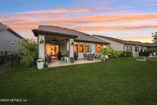 600 Broomsedge Cir, Saint Augustine, FL 32095 - back of property at dusk featuring ceiling fan, a patio area, a fenced backyard, and roof with shingles