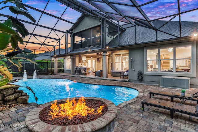 528 Sebastian Sq, Saint Augustine, FL 32095 - pool at dusk featuring a fire pit, an outdoor pool, a patio area, and a lanai
