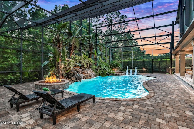528 Sebastian Sq, Saint Augustine, FL 32095 - pool at dusk with an outdoor fire pit, a lanai, a patio area, and an outdoor pool