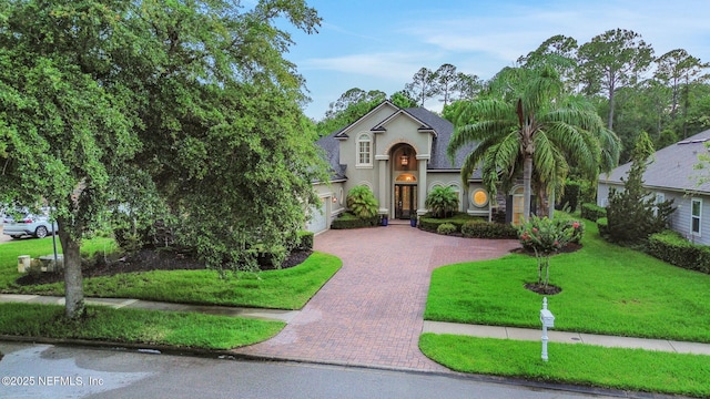 528 Sebastian Sq, Saint Augustine, FL 32095 - view of front of house featuring decorative driveway, stucco siding, an attached garage, and a front lawn