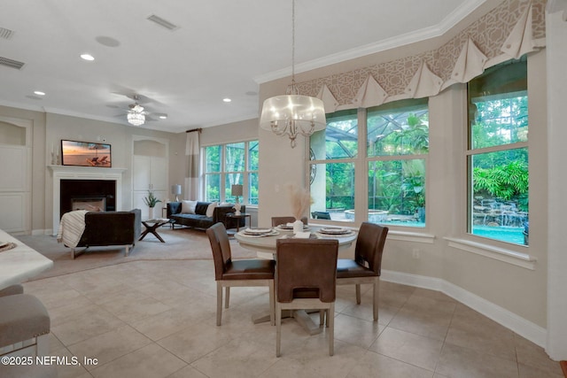 528 Sebastian Sq, Saint Augustine, FL 32095 - dining area with crown molding, healthy amount of natural light, a glass covered fireplace, light tile patterned floors, and recessed lighting