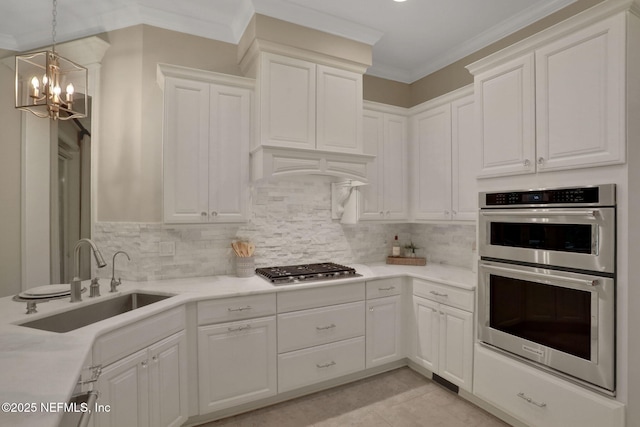 528 Sebastian Sq, Saint Augustine, FL 32095 - kitchen with appliances with stainless steel finishes, a chandelier, light countertops, white cabinets, and backsplash
