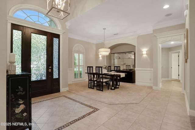 528 Sebastian Sq, Saint Augustine, FL 32095 - foyer entrance with arched walkways, a chandelier, crown molding, light tile patterned floors, and recessed lighting