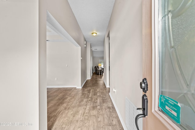 1861 Heartpine Dr, Middleburg, FL 32068 - foyer entrance featuring light wood-style flooring, baseboards, and a textured ceiling