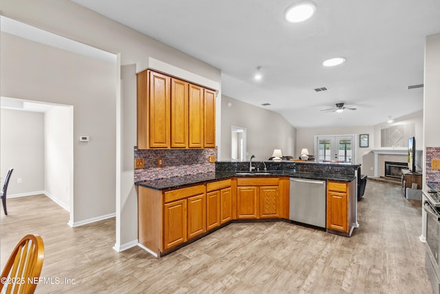 1861 Heartpine Dr, Middleburg, FL 32068 - kitchen with dishwasher, a glass covered fireplace, a ceiling fan, a peninsula, and light wood finished floors