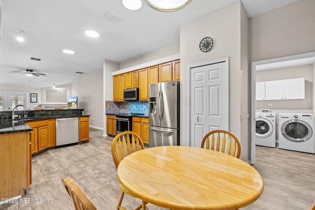 1861 Heartpine Dr, Middleburg, FL 32068 - kitchen with stainless steel appliances, washer and clothes dryer, light wood finished floors, a ceiling fan, and recessed lighting
