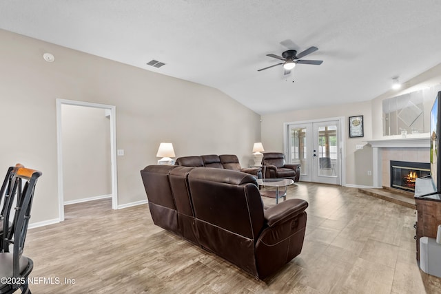1861 Heartpine Dr, Middleburg, FL 32068 - living room with french doors, ceiling fan, a tile fireplace, lofted ceiling, and baseboards