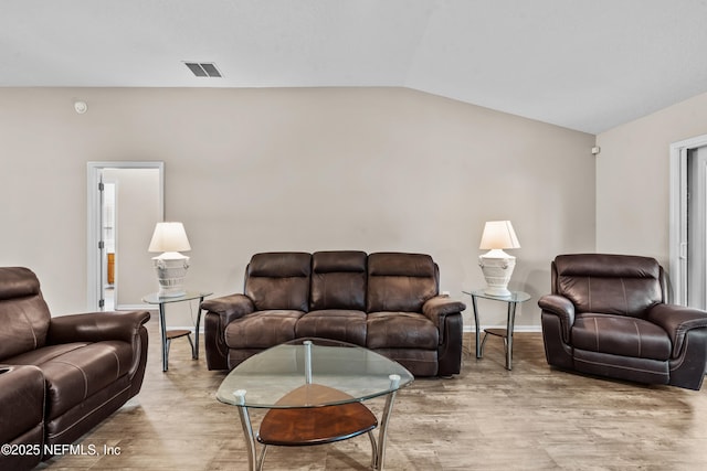 1861 Heartpine Dr, Middleburg, FL 32068 - living area featuring vaulted ceiling, light wood-style floors, and baseboards