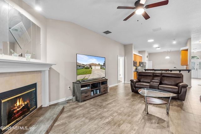 1861 Heartpine Dr, Middleburg, FL 32068 - living room featuring ceiling fan, a tile fireplace, light wood finished floors, and baseboards