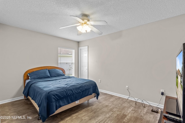 1861 Heartpine Dr, Middleburg, FL 32068 - bedroom with wood finished floors, a textured ceiling, baseboards, and ceiling fan