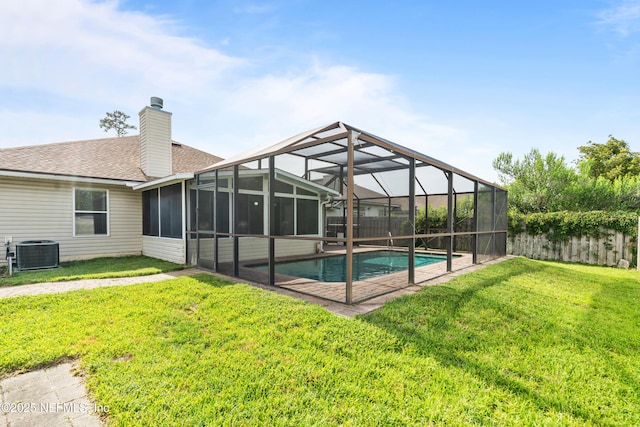 1861 Heartpine Dr, Middleburg, FL 32068 - rear view of property featuring central AC, an outdoor pool, a chimney, roof with shingles, and a lanai