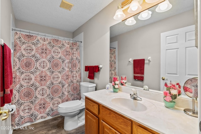 1861 Heartpine Dr, Middleburg, FL 32068 - bathroom featuring vanity, wood finished floors, toilet, a textured ceiling, and a shower with curtain