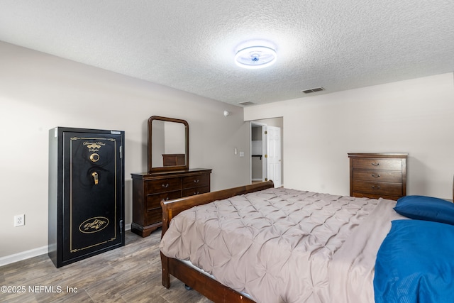 1861 Heartpine Dr, Middleburg, FL 32068 - bedroom with wood finished floors, a textured ceiling, and baseboards