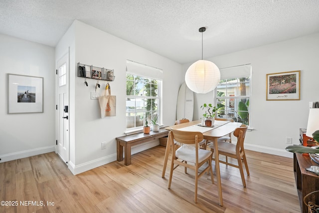 1848 Forsyth Ct, Atlantic Beach, FL 32233 - dining room with light wood-style flooring and a textured ceiling