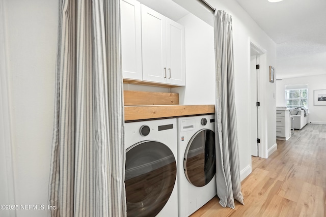 1848 Forsyth Ct, Atlantic Beach, FL 32233 - washroom featuring separate washer and dryer, light wood-style flooring, and cabinet space