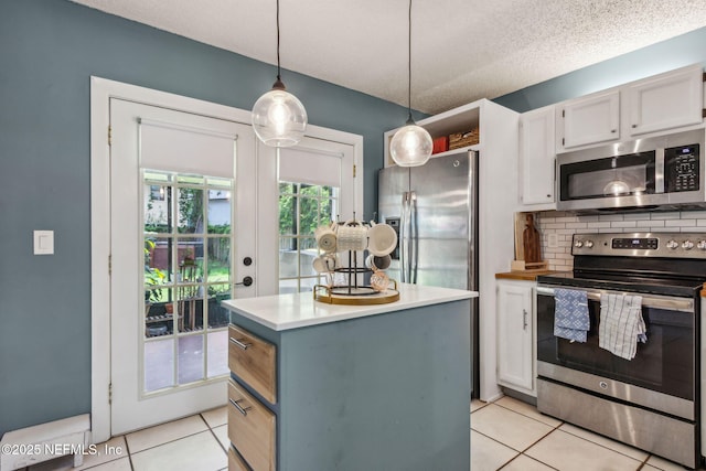 11461 Willet Ct S, Jacksonville, FL 32225 - kitchen featuring stainless steel appliances, light tile patterned floors, a center island, pendant lighting, and light countertops