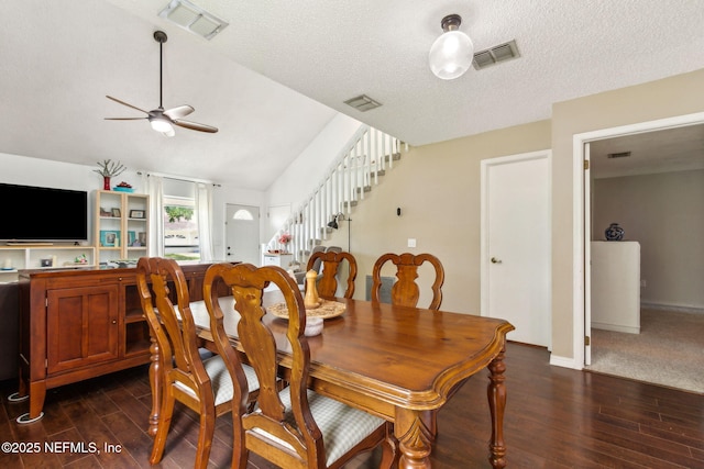 11461 Willet Ct S, Jacksonville, FL 32225 - dining area with dark wood-style flooring, a ceiling fan, stairs, vaulted ceiling, and a textured ceiling