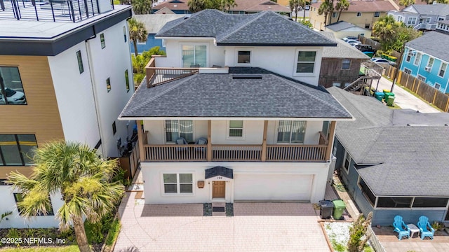 126 1st St S, Jacksonville Beach, FL 32250 - view of front of home with stucco siding, a balcony, a residential view, and a garage