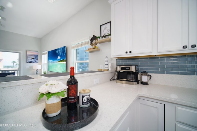 126 1st St S, Jacksonville Beach, FL 32250 - kitchen featuring open shelves, tasteful backsplash, and white cabinets