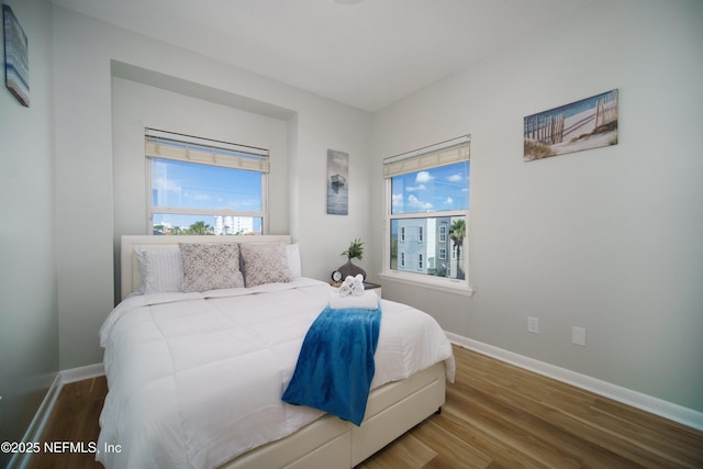 126 1st St S, Jacksonville Beach, FL 32250 - bedroom featuring multiple windows, wood finished floors, and baseboards