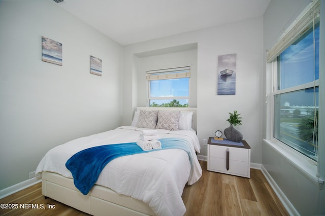 126 1st St S, Jacksonville Beach, FL 32250 - bedroom featuring wood finished floors and baseboards