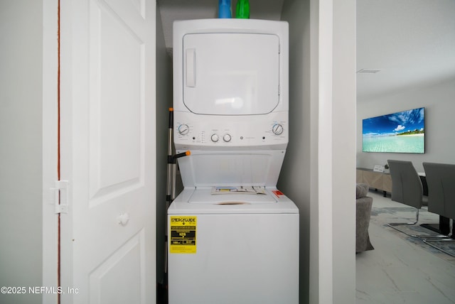 126 1st St S, Jacksonville Beach, FL 32250 - laundry area featuring stacked washer and clothes dryer and marble look tile flooring
