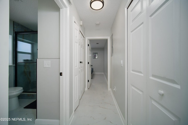 126 1st St S, Jacksonville Beach, FL 32250 - hallway with light marble finish flooring, a textured ceiling, and baseboards