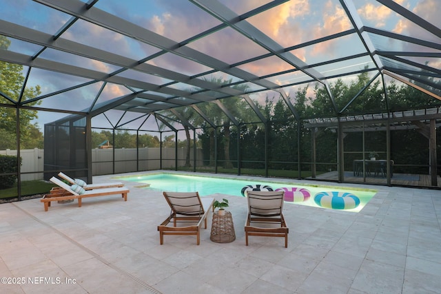 186 Citrus Ridge Dr, Ponte Vedra, FL 32081 - pool at dusk featuring a fenced backyard, a patio area, and glass enclosure