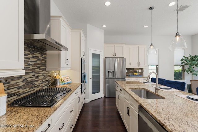 186 Citrus Ridge Dr, Ponte Vedra, FL 32081 - kitchen with wall chimney range hood, appliances with stainless steel finishes, white cabinetry, pendant lighting, and recessed lighting
