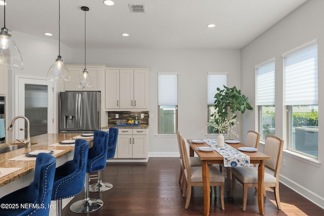 186 Citrus Ridge Dr, Ponte Vedra, FL 32081 - kitchen with appliances with stainless steel finishes, light stone countertops, backsplash, decorative light fixtures, and white cabinets