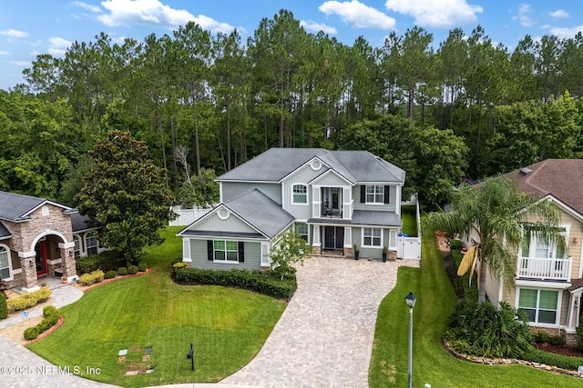 448 Willow Winds Pkwy, Saint Johns, FL 32259 - traditional-style home featuring driveway, a front lawn, a balcony, and board and batten siding