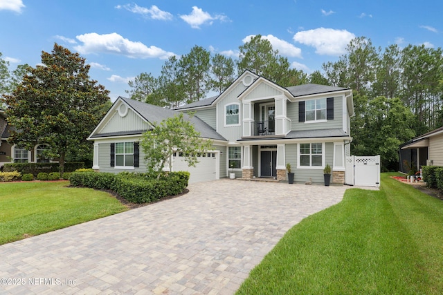 448 Willow Winds Pkwy, Saint Johns, FL 32259 - craftsman house featuring a balcony, stone siding, decorative driveway, and a front yard
