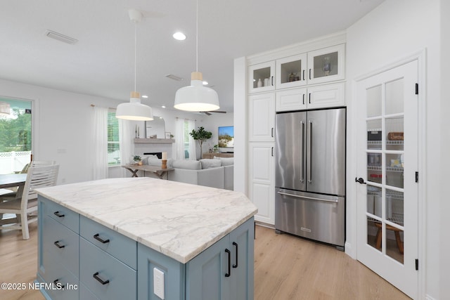 448 Willow Winds Pkwy, Saint Johns, FL 32259 - kitchen with high quality fridge, light wood-style floors, white cabinetry, decorative light fixtures, and recessed lighting