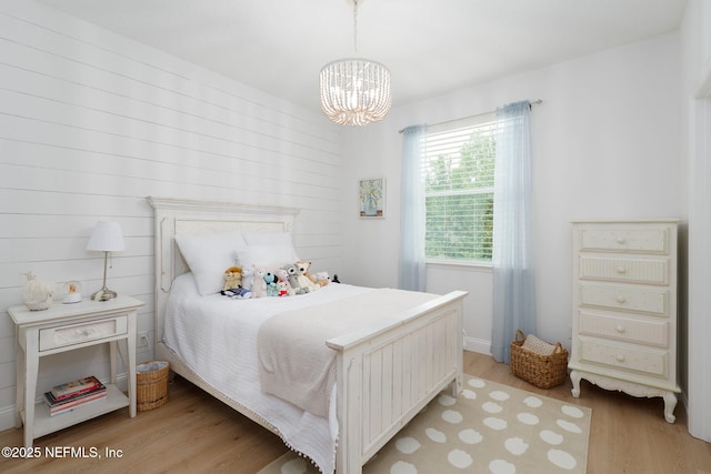 448 Willow Winds Pkwy, Saint Johns, FL 32259 - bedroom with light wood-style floors and a chandelier