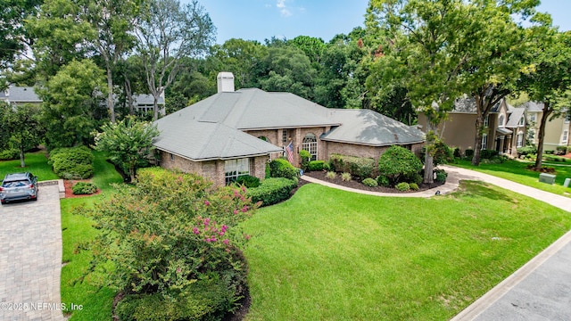 12921 Jupiter Hills Cir N, Jacksonville, FL 32225 - ranch-style home featuring a front yard, brick siding, and a chimney